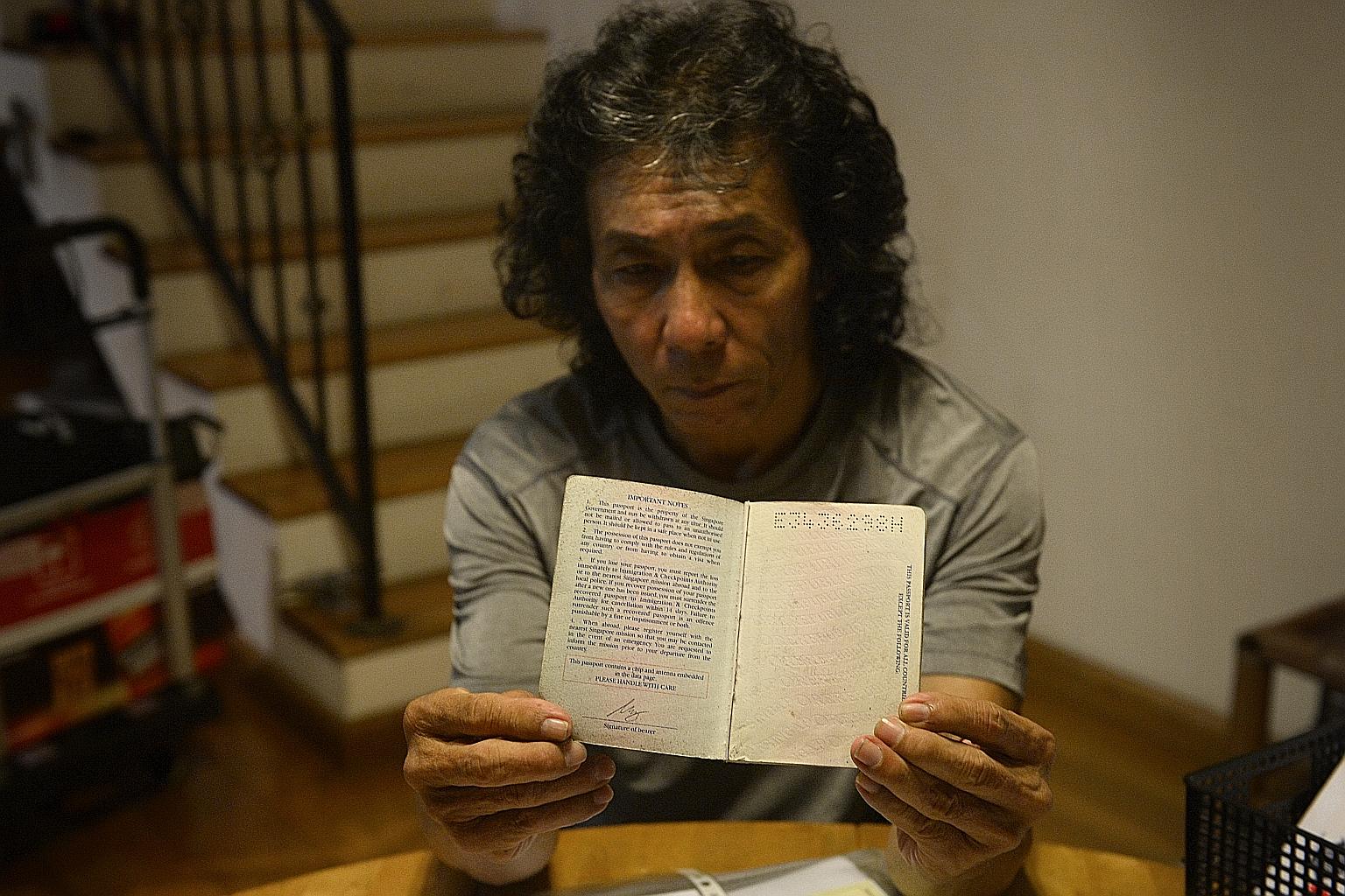 Mr Jack Sim holding up his late son Leonard's passport, which had the page with his biometric data cleanly cut out. The younger Mr Sim's friend discovered that the page was missing at the accident site.