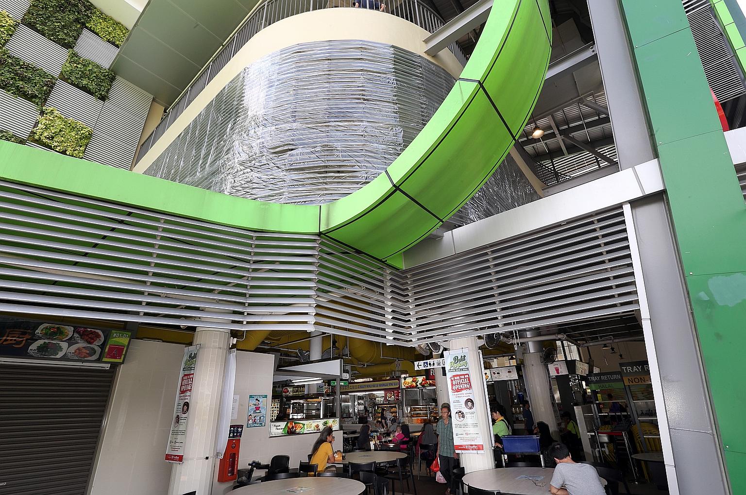 Plastic sheets are being used to cover the louvre panels (left) and the top of stalls (below) at Bukit Panjang Hawker Centre and Market to keep out rainwater.