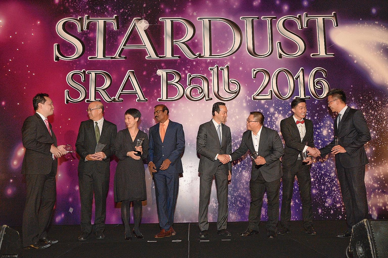 The six SRA retail awards were received by (from left) Changi Airport Group's Edwin Lim, for best retail event; NTUC Fairprice's Peter Teo, for best new entrant; DFS Venture Singapore's Wilcy Wong, for best retail concept; Mr Dhinakaran; Dr Koh; Sing