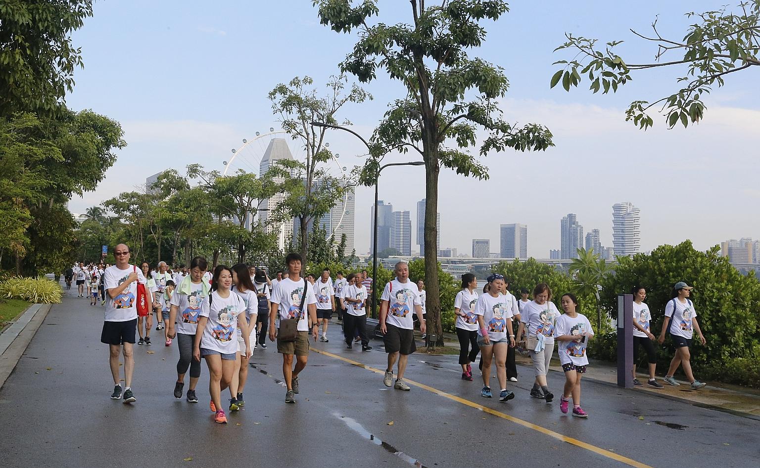 Participants of the 3km walk that took place around Gardens by the Bay and Marina Barrage yesterday. The cabbies were joined by 250 family members, as well as Health Minister Gan Kim Yong, who flagged off the walk.