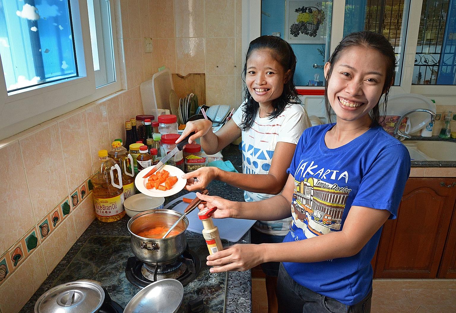 Indonesians Wiwik Mariyati, 34, and Carsih Carman Taja (far right), 29, work here as domestic helpers. The number of helpers like them as well as dependants on long-term visit passes, grew over the past year, contributing to the growth in non-residen