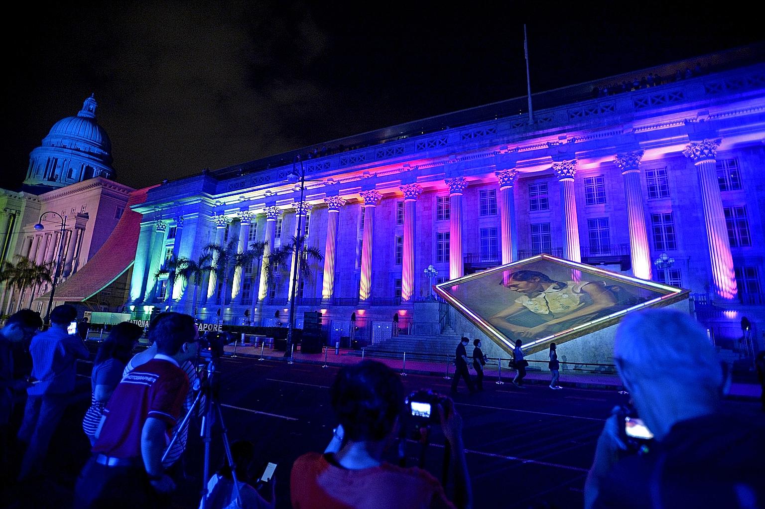 Images being projected onto the facade of the National Gallery Singapore during its grand opening on Nov 27 last year. The gallery saw tens of thousands of visitors in its first week.