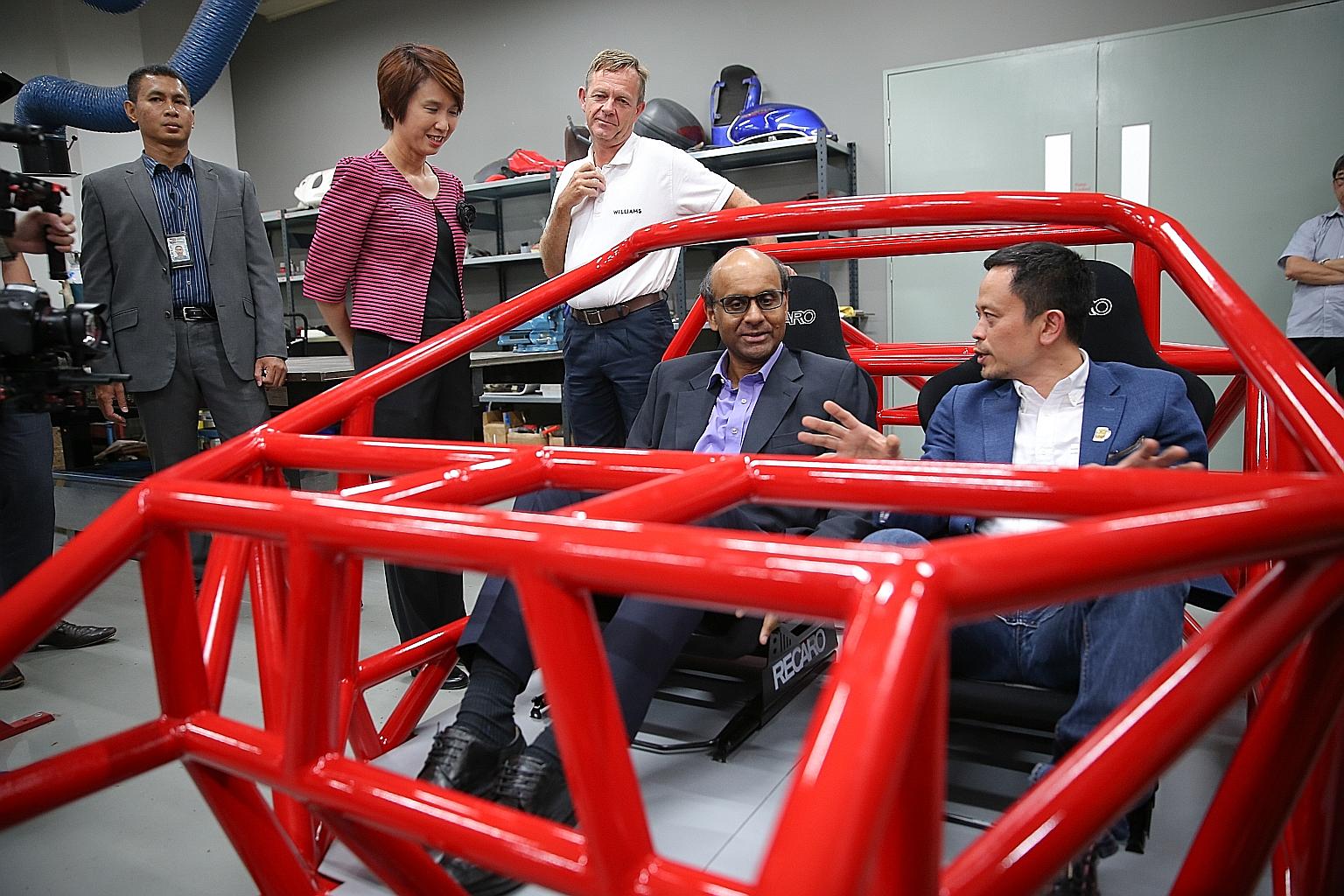 Mr Tharman sitting in a Dendrobium hypercar space frame built by the research and development arm of Wong Fong Industries. With him are Wong Fong Industries executive director Eric Lew (right) and Parliamentary Secretary Low Yen Ling.
