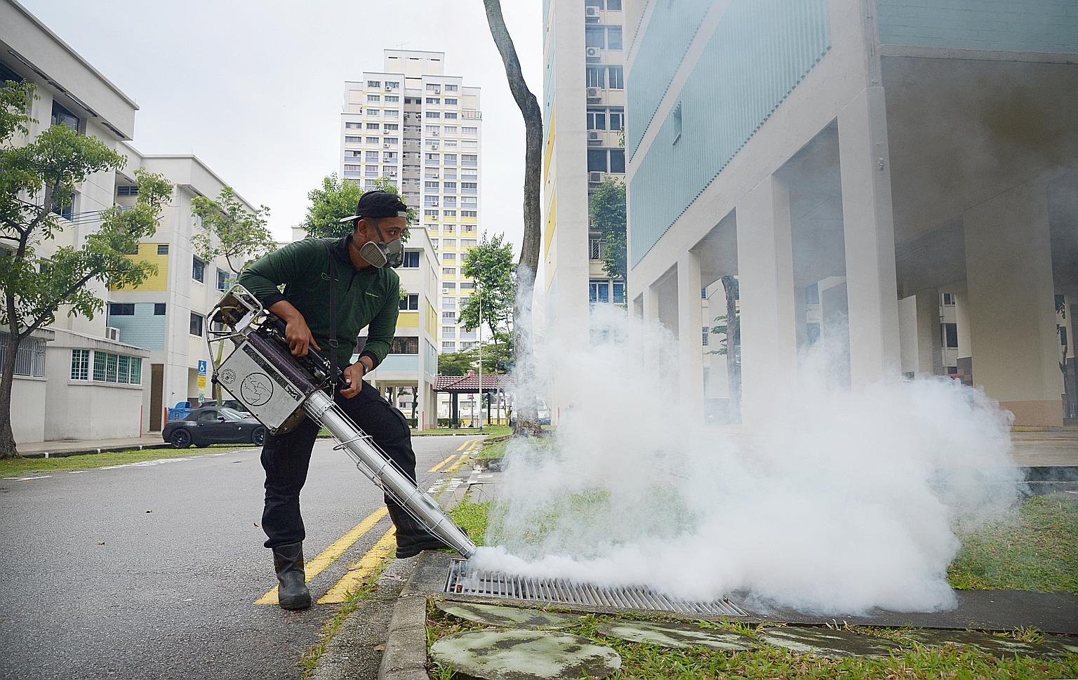 A contractor engaged by the town council fumigating the precinct of Bishan earlier this month.