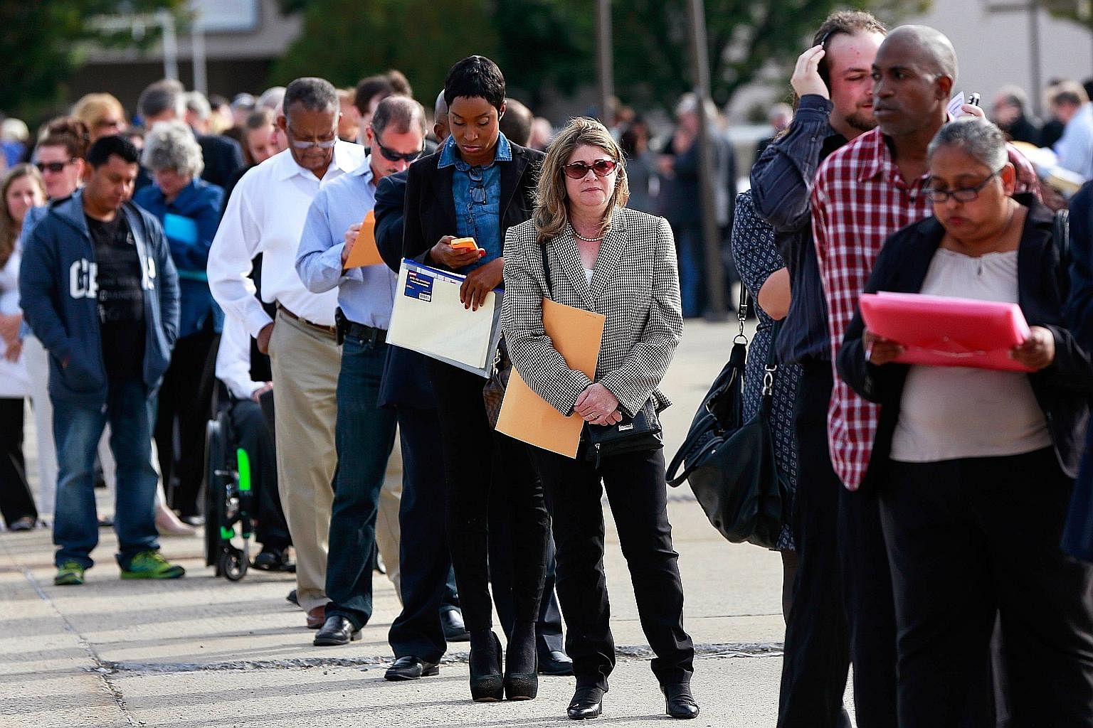 People waiting in line to enter a job fair in New York.Americans have been moving away from a system in which a good job with a generous employer was the key to a good life, to a new system in which even people with low-wage jobs can have access to t
