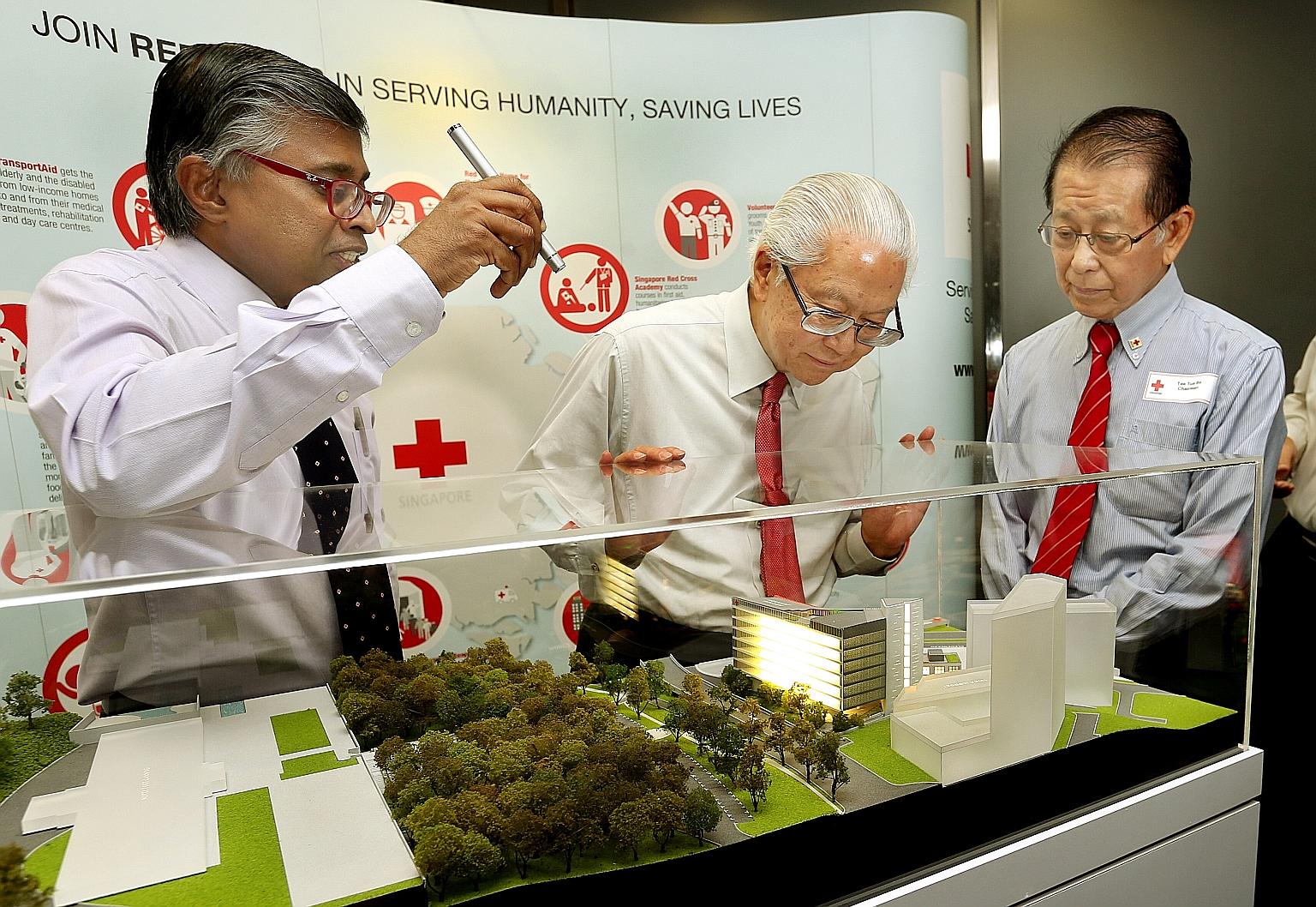 From far left: SRC secretary- general Benjamin William; SRC's patron, President Tony Tan Keng Yam; and SRC chairman Tee Tua Ba with a model of the SRC's new building, which will be located beside its current building.