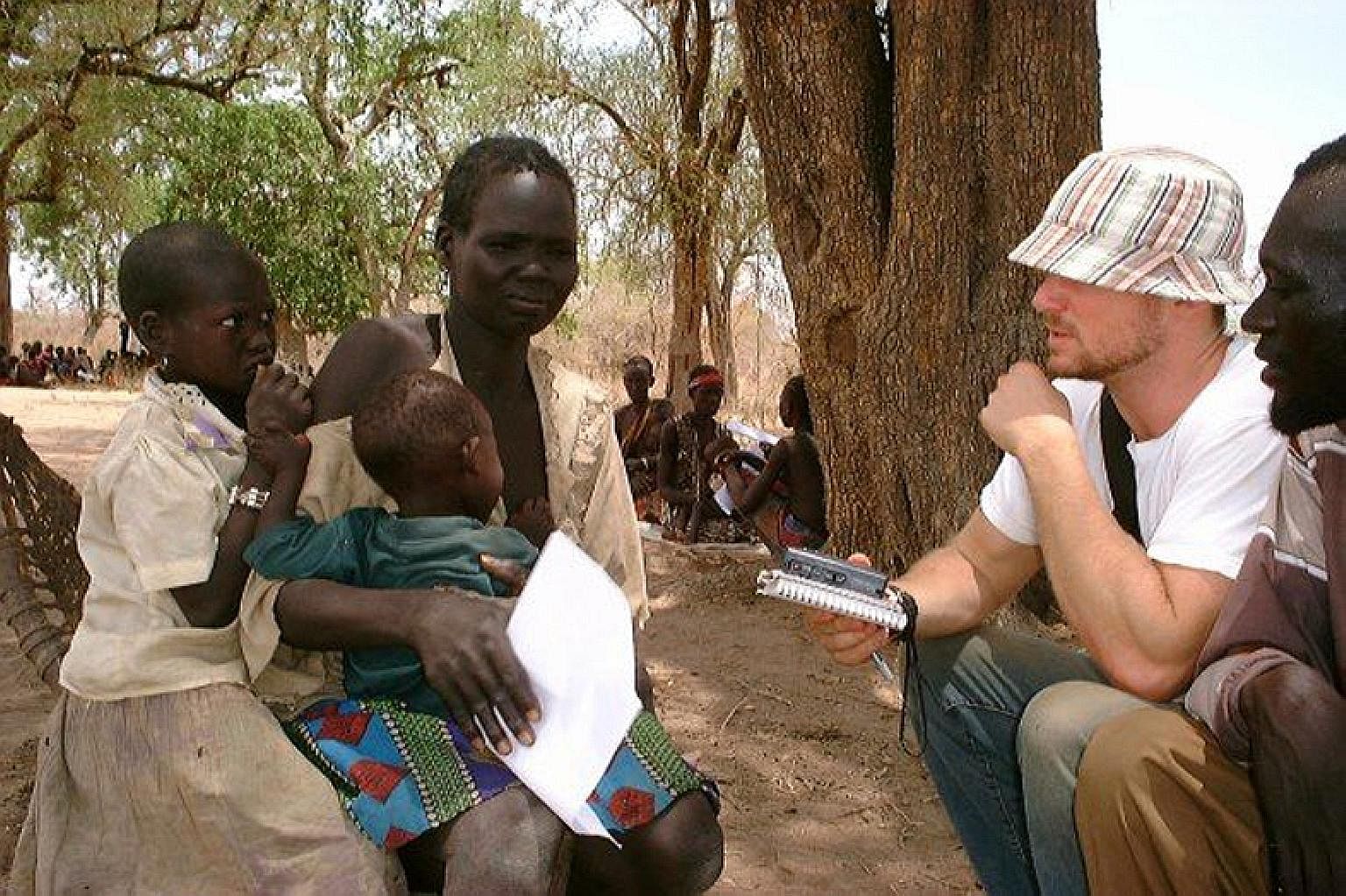 Mr Skinner on assignment in Sudan in 2003. He had persuaded Newsweek to let him fly to the front lines of the civil war there where slavery and human trafficking were booming. In Haiti, a man - just one of many traffickers who procure children from i