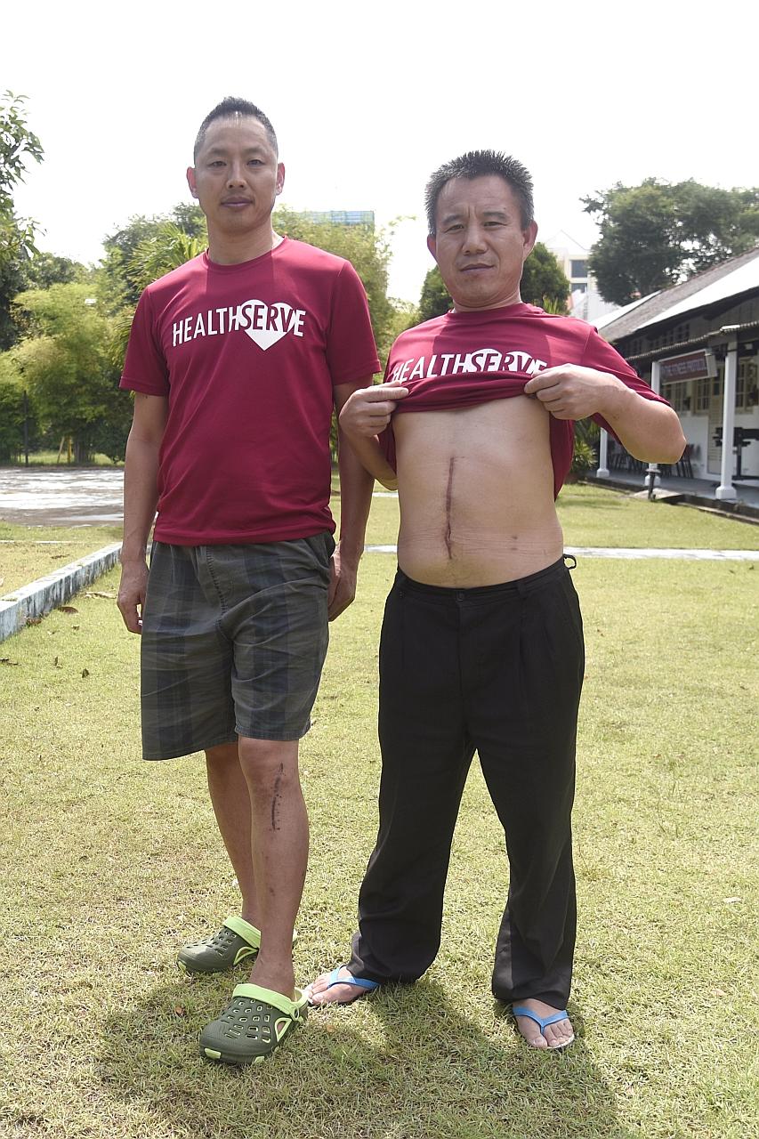 Construction worker Qiu Lin Min (far left) and carpenter Zhao Lian Wei were injured on their worksites and remain in Singapore on a Special Pass as they await compensation. Mr Qiu broke his leg while Mr Zhao broke his wrist and had to have his spleen