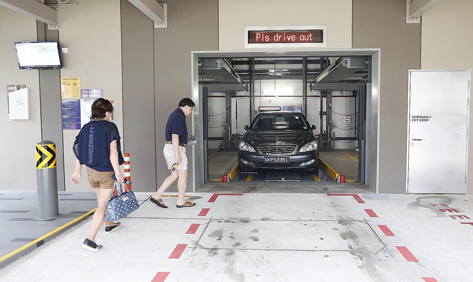 A couple collecting their car from a mechanised carpark in Yishun. While some users say the system is convenient and safe, others feel the waiting time is too long.