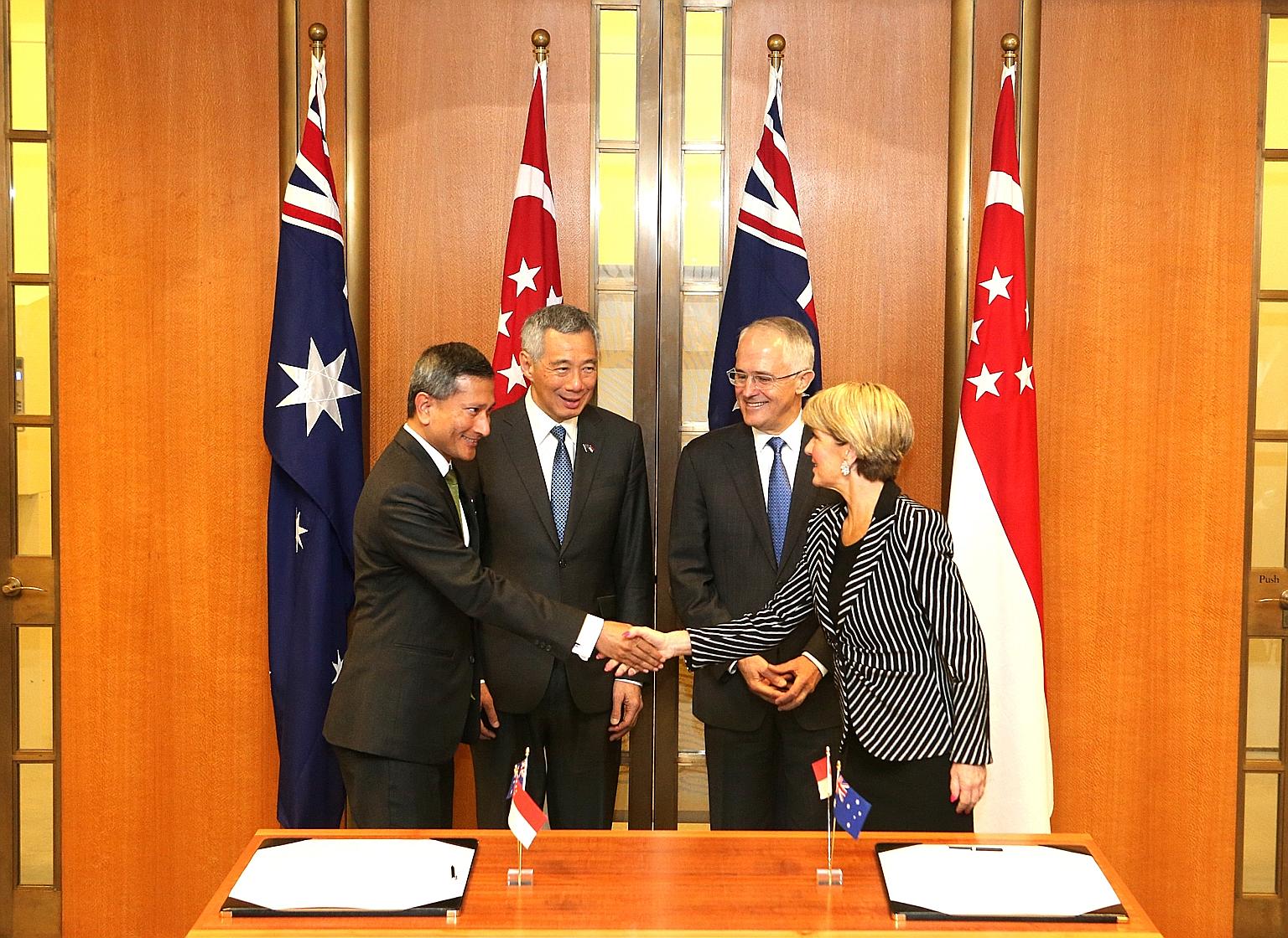 Singapore Foreign Minister Vivian Balakrishnan and his Australian counterpart Julie Bishop acknowledging the signing of a memorandum of understanding on science and innovation, one of the four CSP agreements, in Canberra's Parliament House yesterday,