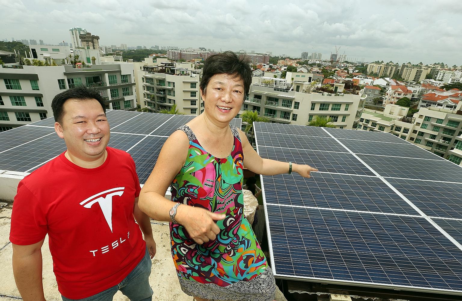 Mrs Pho Hong Ling, 61, and her son Robin on the rooftop of her penthouse condominium in Bukit Timah where 20 solar panels have been installed, generating about 20 kilowatt hours of energy a day. Mr Pho estimates this will help cut about half of the m