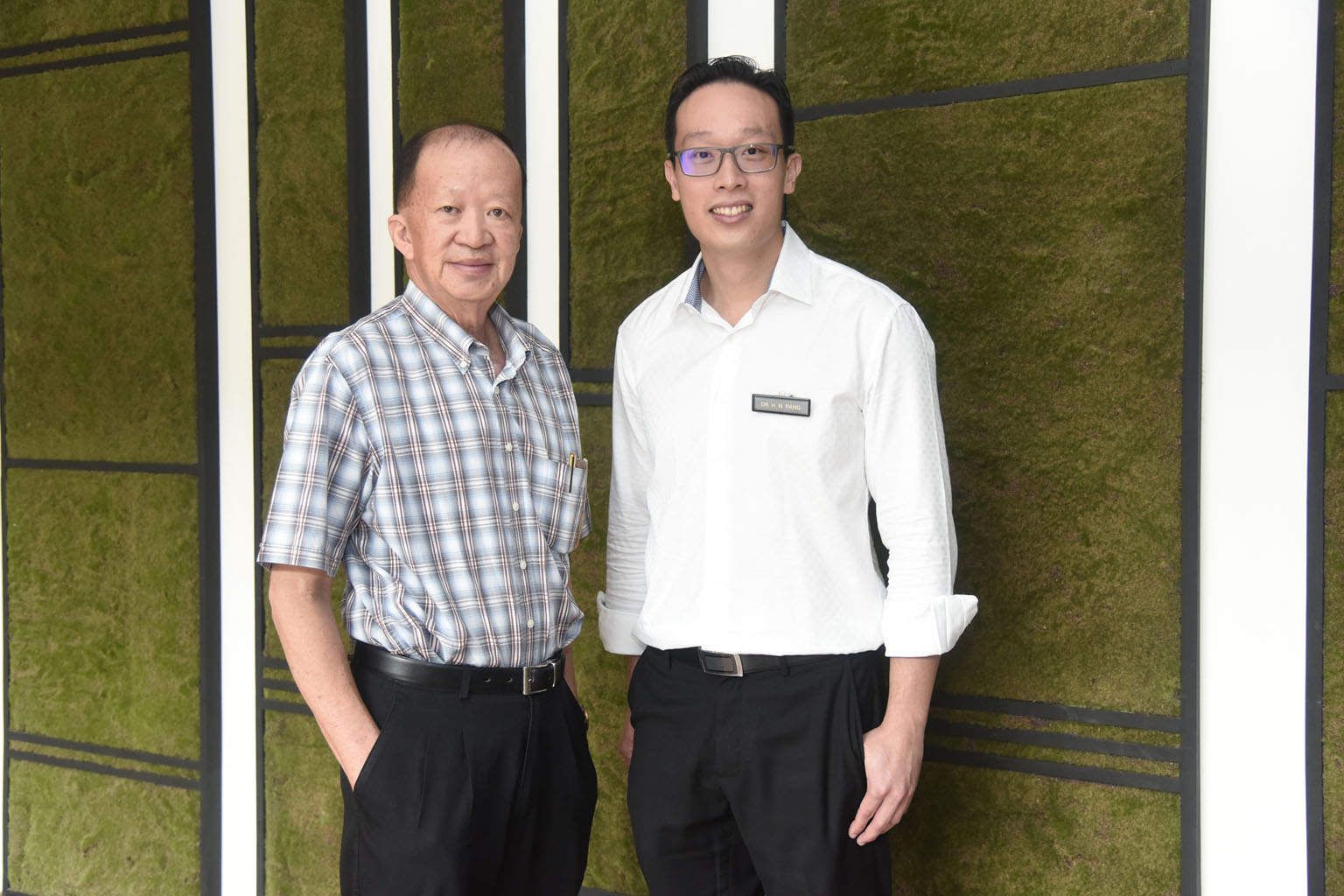 Before his operation, Mr Tiang (far left) could not walk without wincing in pain. But the new method of surgery performed by Dr Pang (left) has improved his mobility radically. 