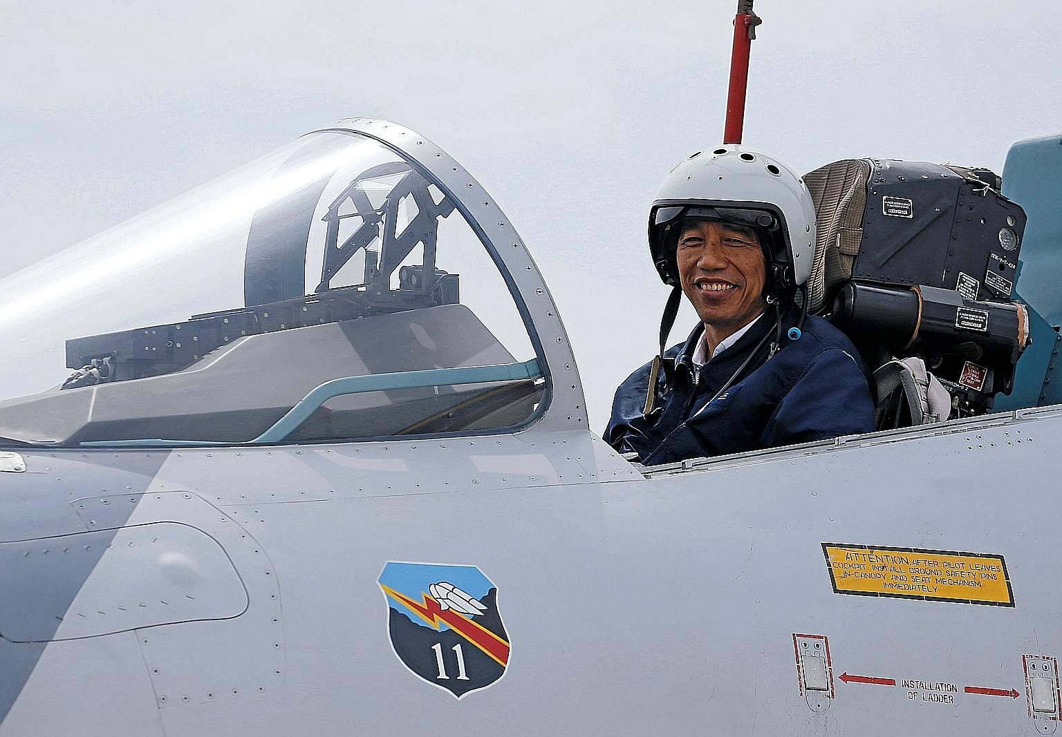 Mr Joko in the cockpit of a fighter jet while attending a military exercise on Oct 6. He has shown that he can rise to the occasion in tough situations.