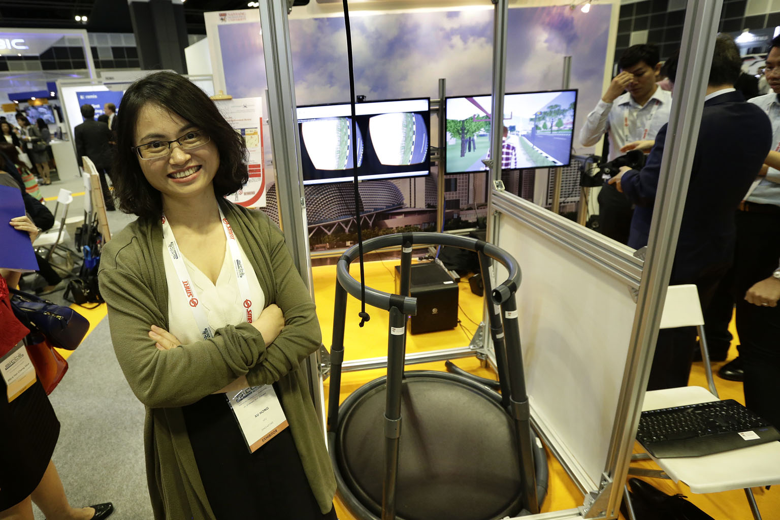 Prof Xu Hong (above) with the virtual reality (VR) walking simulator where a person wearing a VR headset can react to cyclists or PMD users coming their way at different speeds. The simulator is at the three-day Singapore International Transport Congress 