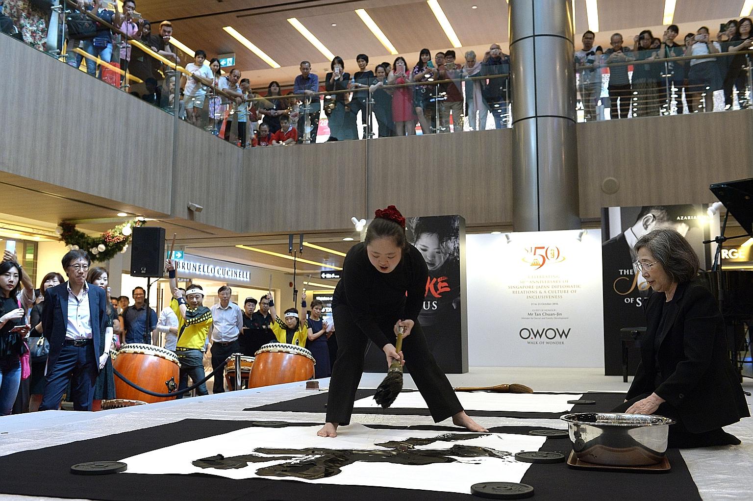 Calligrapher Shoko Kanazawa working on her second calligraphy work - de, or virtue - at Paragon Shopping Mall yesterday. The event, SJ50, was organised to celebrate 50 years of diplomatic relations between Singapore and Japan, as well as to embrace t