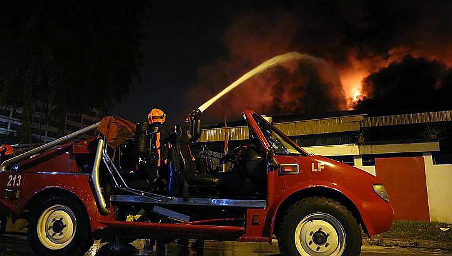 SCDF firefighters working to put out the blaze in Kallang Way on Sept 6, 2012. The High Court found that the blaze started on the premises of Grace Electrical Engineering and ruled that the company is liable for the fire.