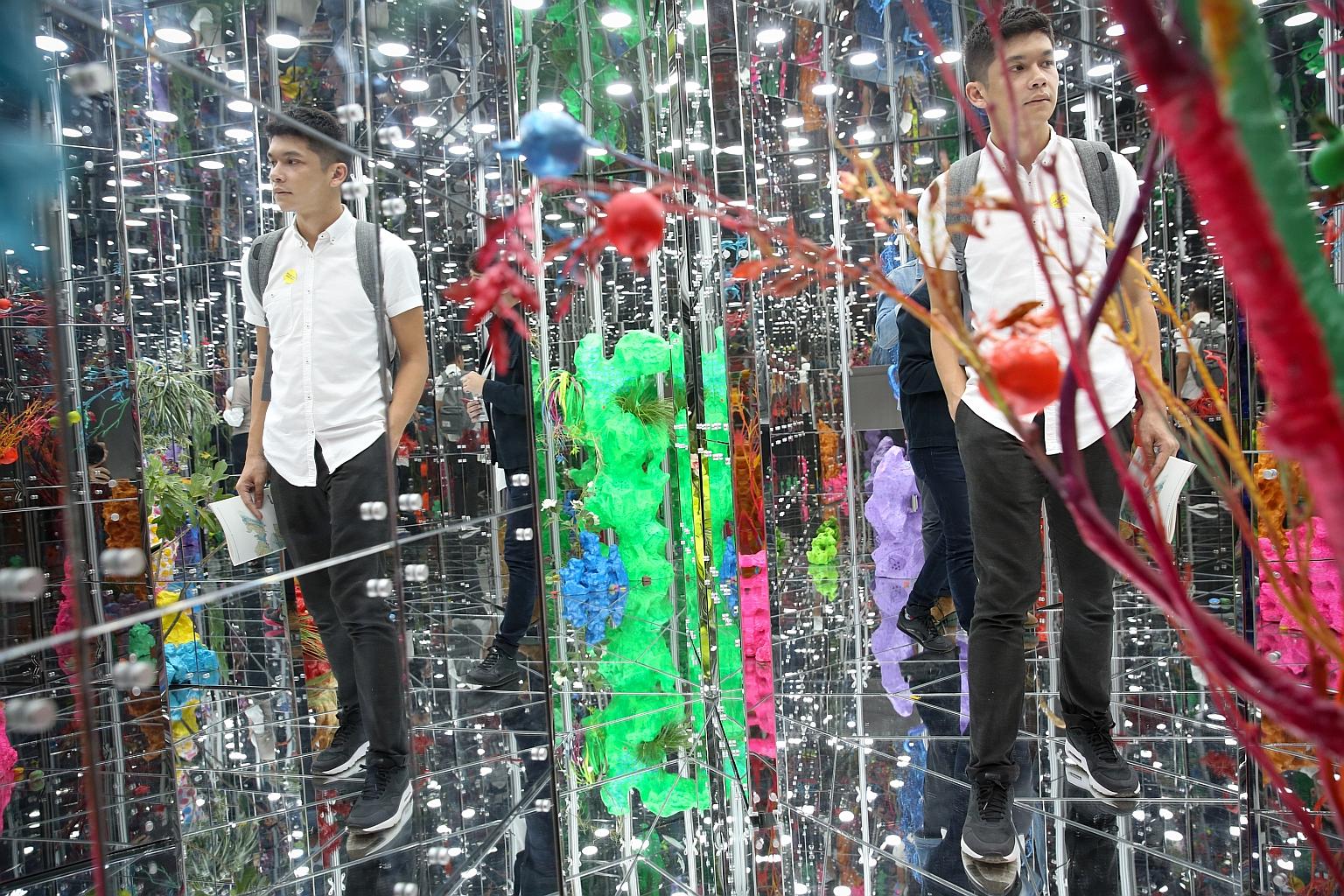 A guest viewing artist Deng Guoyuan's Noah's Garden II during the opening of the Singapore Biennale at the Singapore Art Museum last night. Titled An Atlas Of Mirrors, the fifth edition of the exhibition features 58 works by 63 artists and artist col