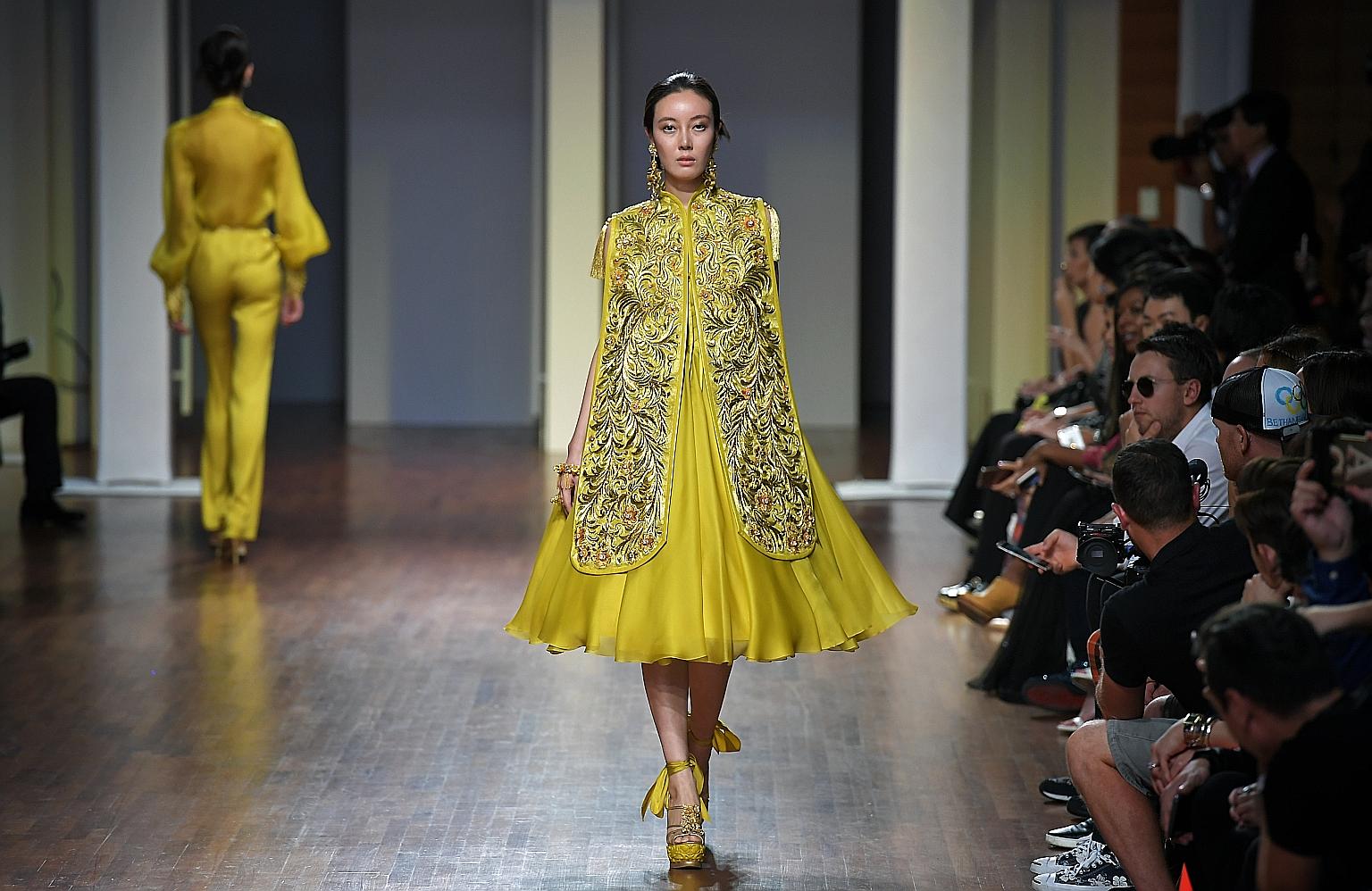 One of the outfits from Chinese designer Guo Pei's show, which opened the five-day Singapore Fashion Week at the National Gallery Singapore last night. The embroidered vest features details of peacock feathers. The line-up of 22 shows at this year's