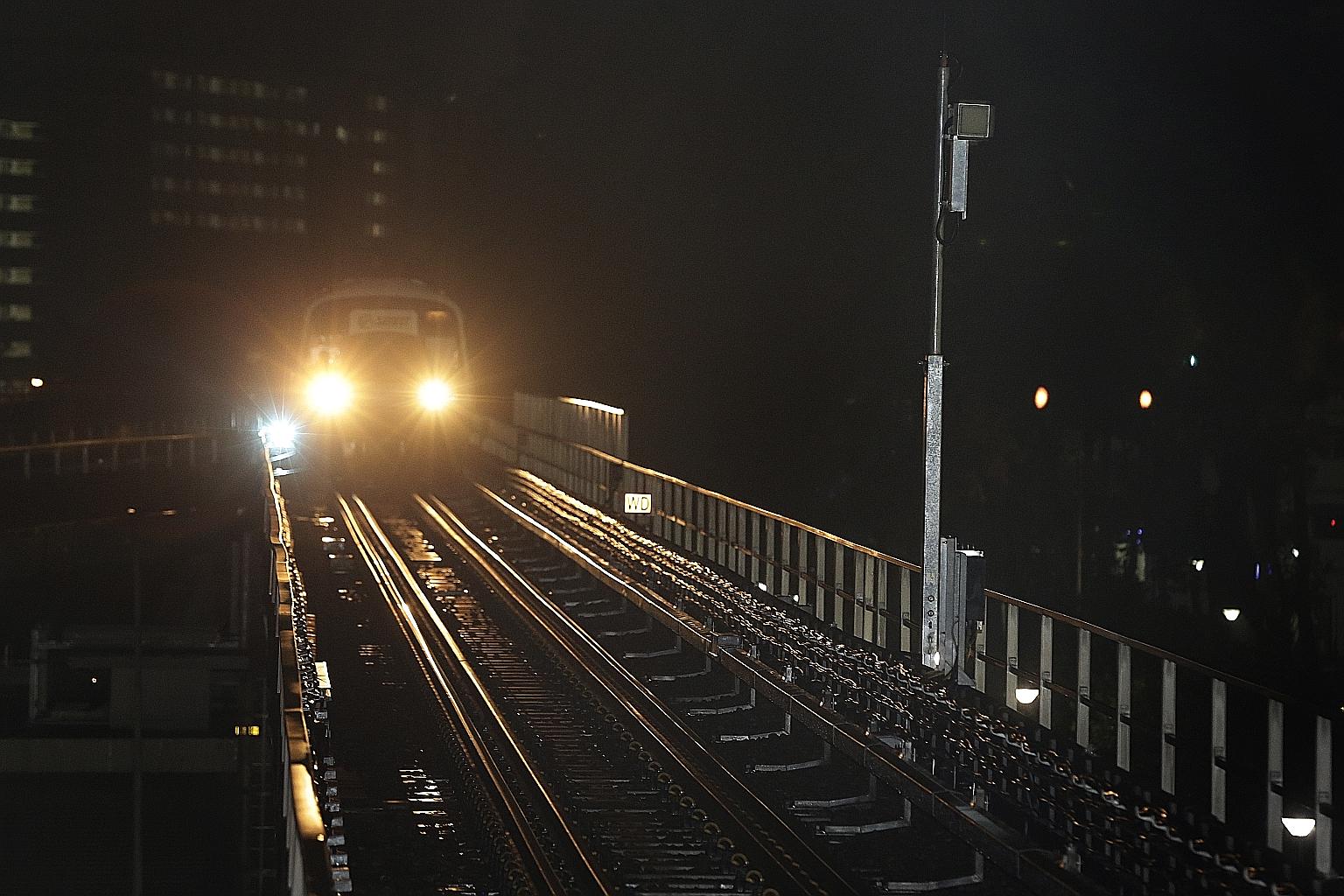 A train approaching a radio antenna (right), which has been installed at the side of the track, during testing for the North-South Line re-signalling project at Woodlands MRT station yesterday.