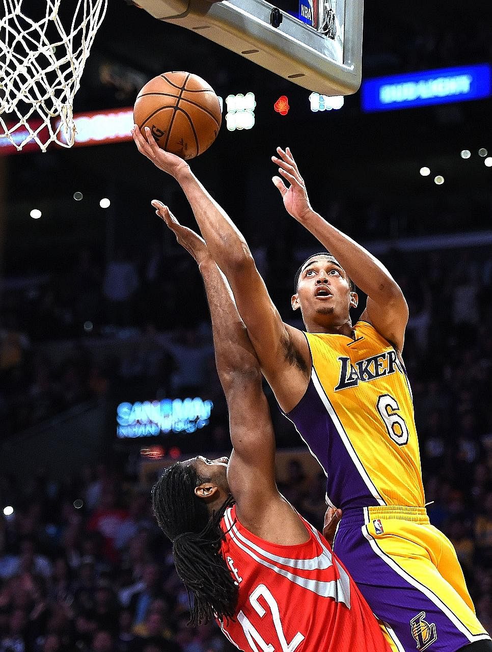 Los Angeles Lakers guard Jordan Clarkson scoring two of his team-high 25 points over the Houston Rockets' Nene Hilario during the Lakers' 120-114 season-opening win at the Staples Centre.