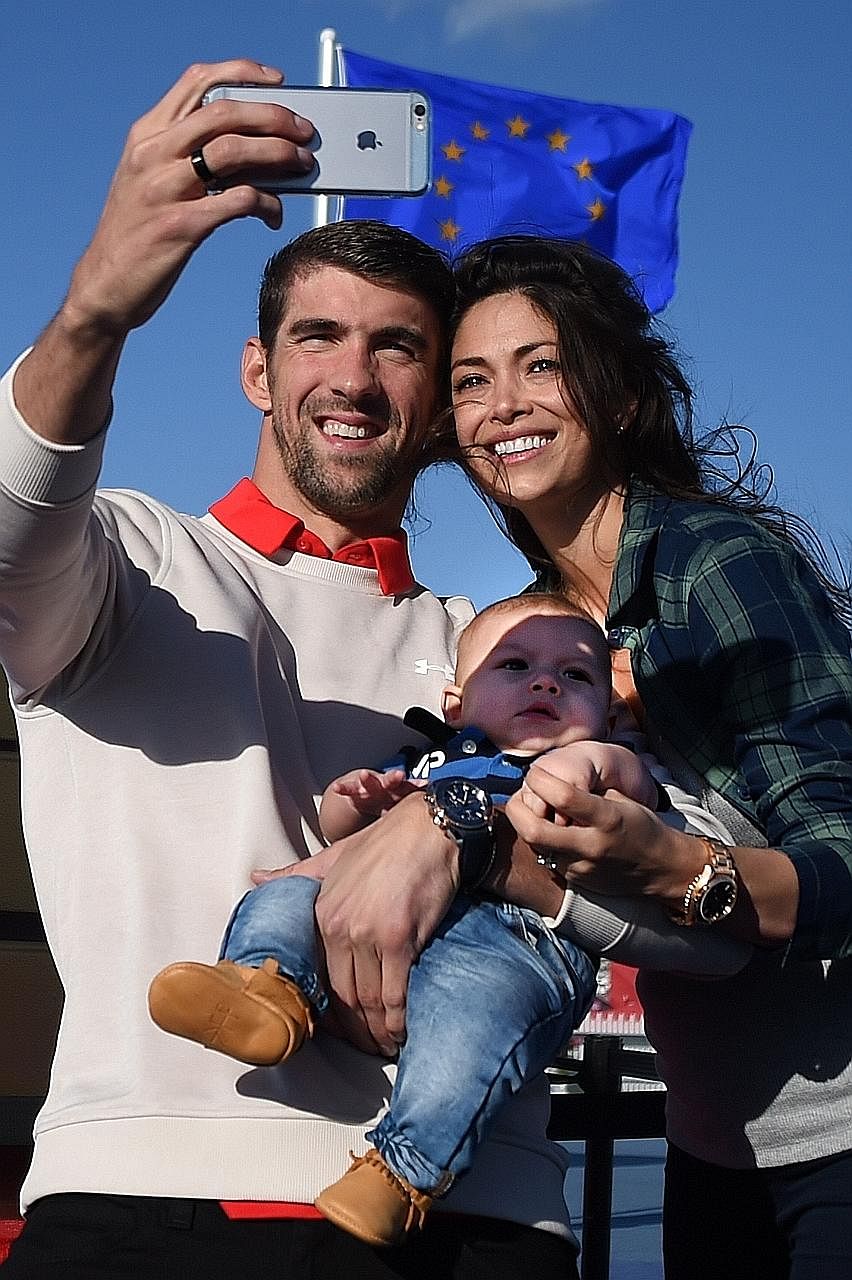 Michael Phelps with Nicole Johnson and their son Boomer at the Ryder Cup golf tournament last month. Court records made public on Thursday revealed that the couple were secretly married in Arizona on June 13.