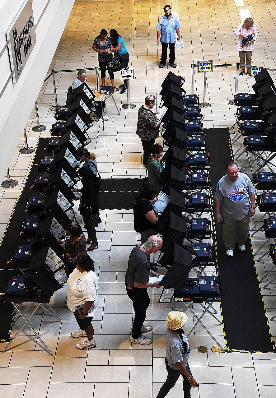 Americans casting ballots at a mall in Las Vegas, Nevada, last Wednesday under an early voting scheme. Come Nov 8, the nation shall see whether the silent majority can hold out against the more clamorous minority.