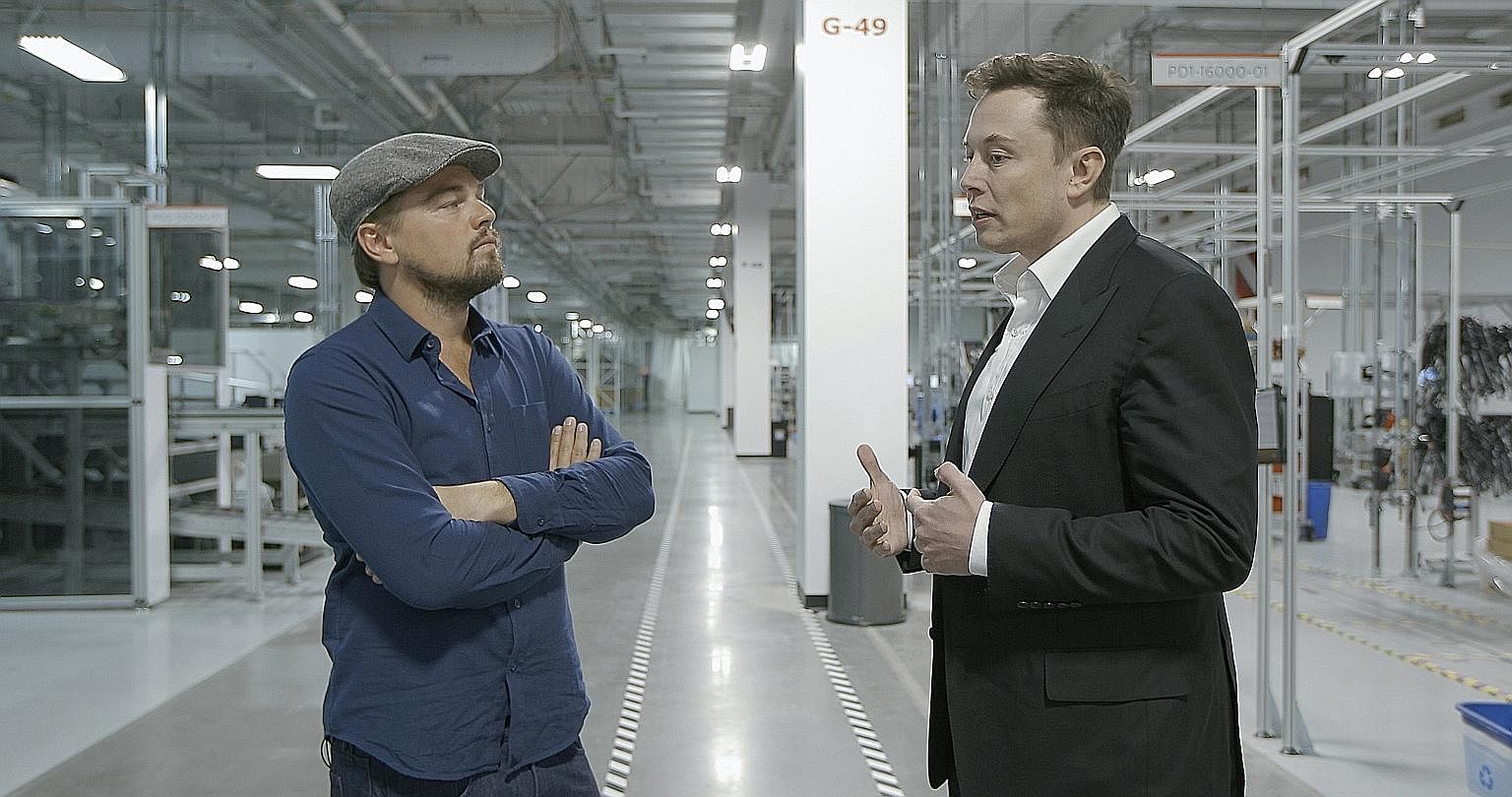 Leonardo DiCaprio (far left) with Tesla founder Elon Musk in Before The Flood.