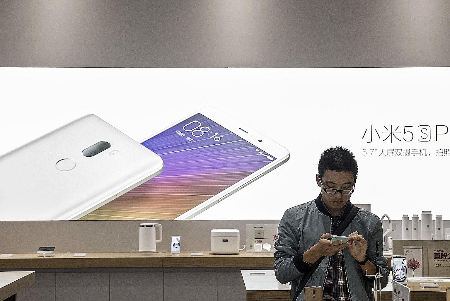 A customer checking out a Xiaomi smartphone in a Beijing store. How Xiaomi's gamble with the Mi Mix pans out will become evident over the next few months.