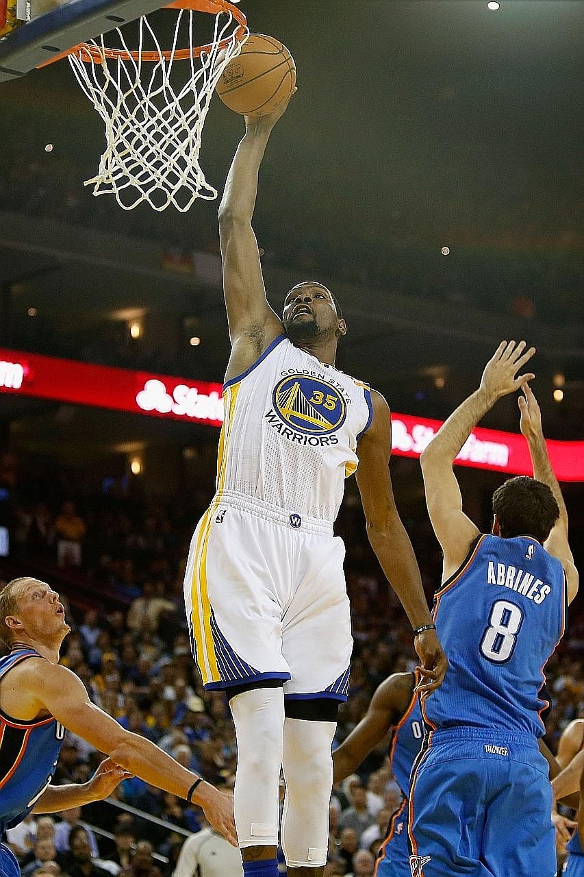 Kevin Durant going up to dunk the ball against the Oklahoma City Thunder at Oracle Arena. He top-scored with 39 points against his former team-mates, including seven three-pointers as the Warriors won 122-96.