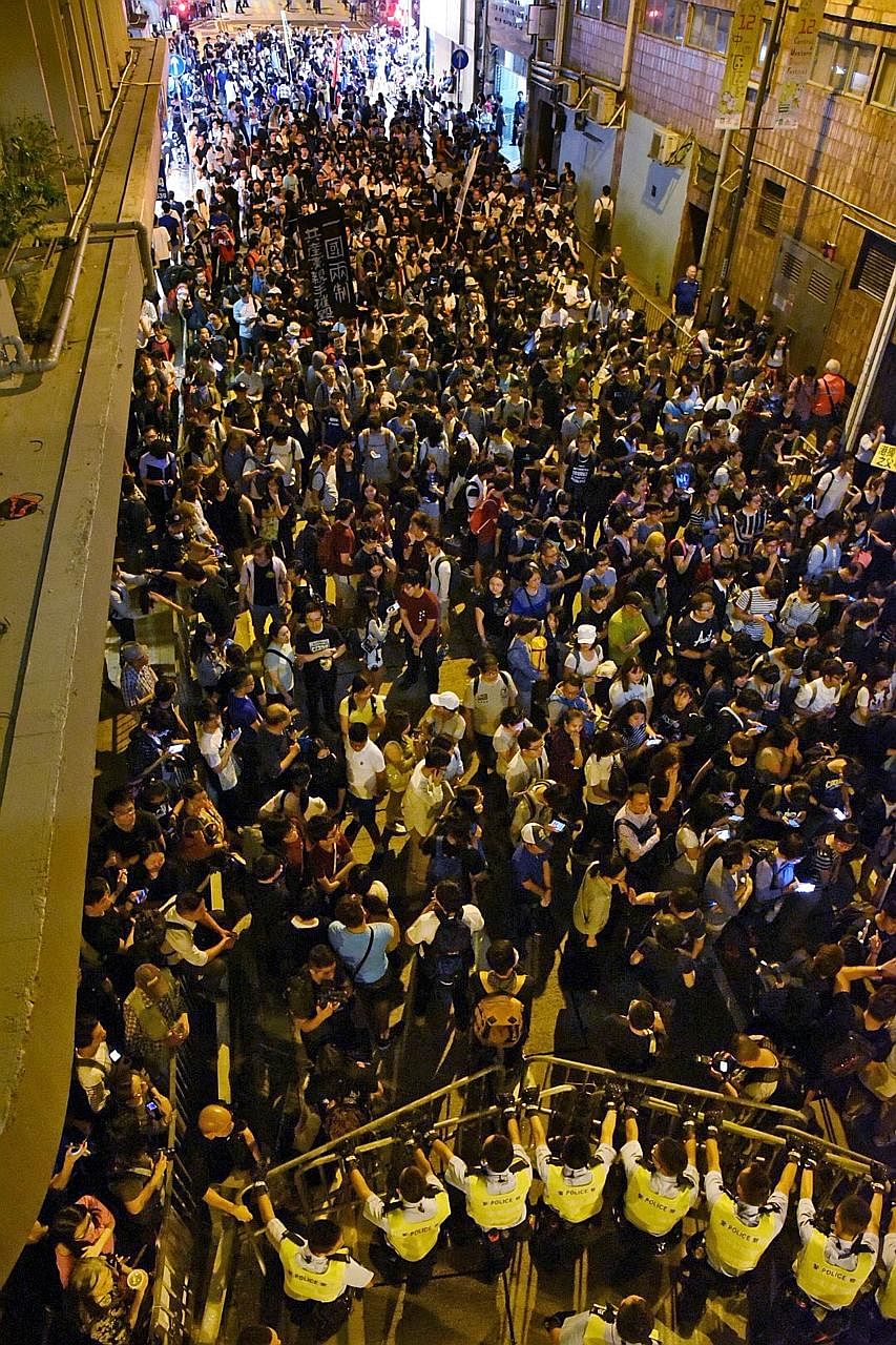 Police using pepper spray to disperse protesters during yesterday's protest in Hong Kong. As of 10pm, at least four groups of protesters were still in stand-offs with police. Protesters facing off against police in Hong Kong last night, the eve of a 