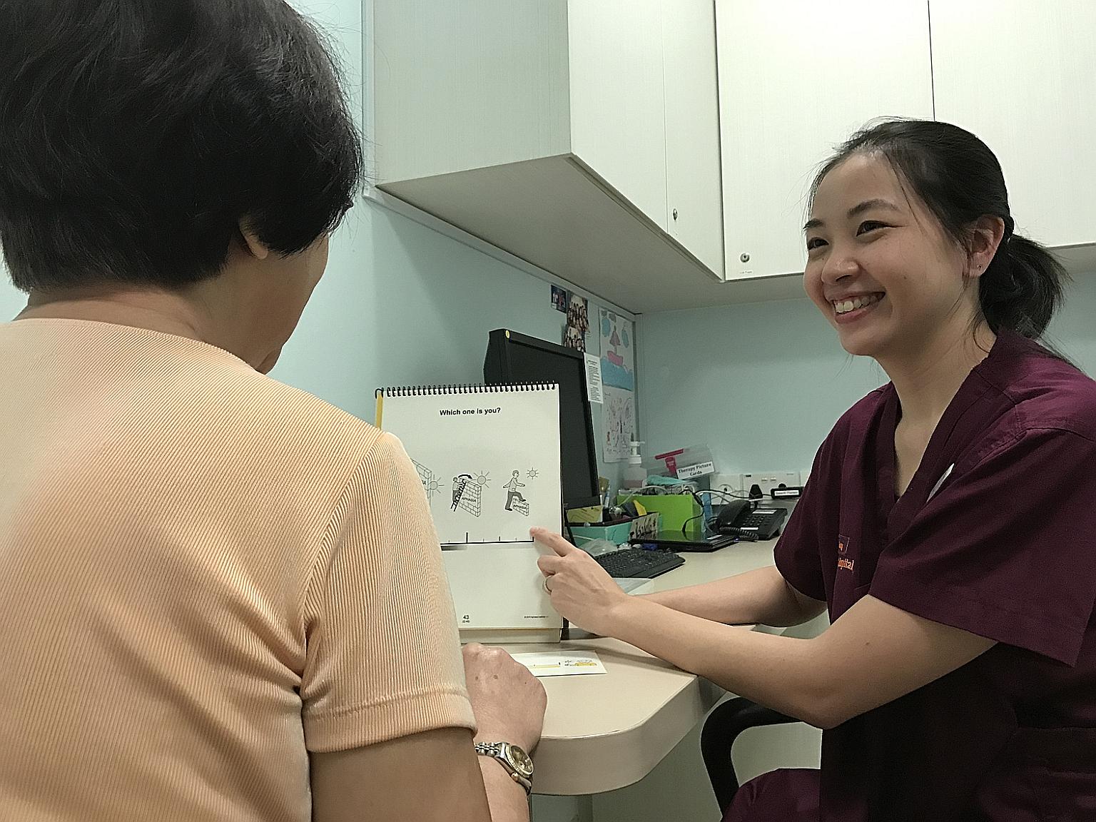Dr Emily Guo using the Assessment for Living with Aphasia toolkit to assess the quality of life of a patient. The National University Hospital is the first to introduce the toolkit in its clinics.