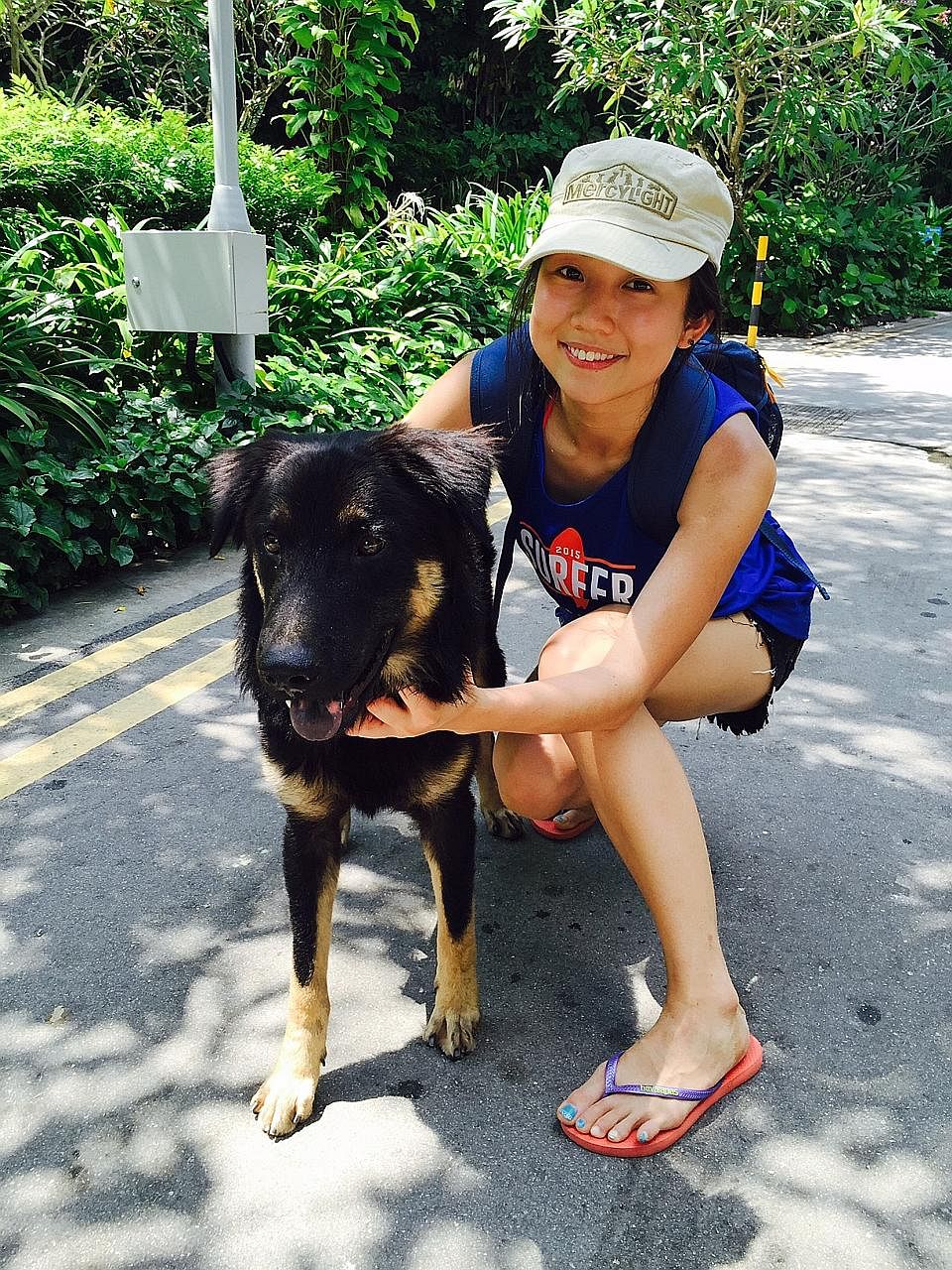 Reporter Audrey Tan in Sentosa last year with a dog from animal shelter Mercylight. The shelter had organised a day out to the beach for its dogs.