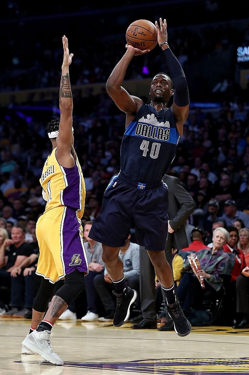The Mavs' Harrison Barnes shooting over the Lakers' D'Angelo Russell in Dallas' 109-97 win. The forward scored 31 points.