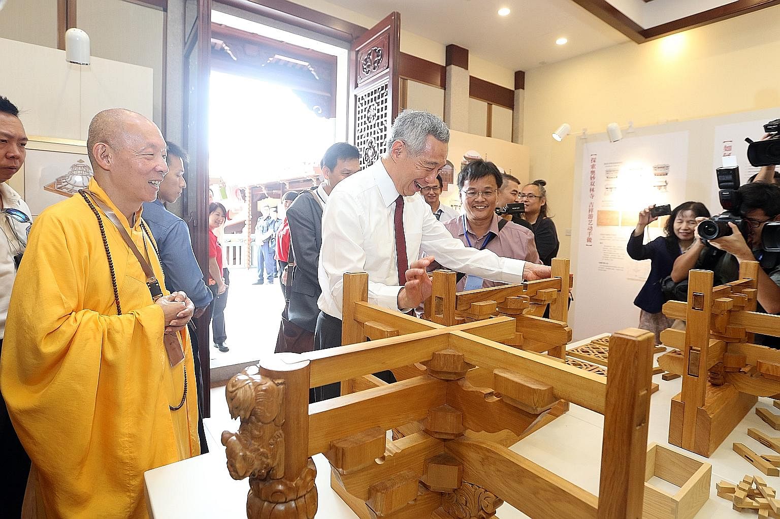 Above: The Meditation Hall is among the new halls added in the $20 million second phase of the Lian Shan Shuang Lin Monastery's restoration programme. Left: PM Lee trying out the wooden structures in the Dharma Hall at the monastery in Kim Keat yeste