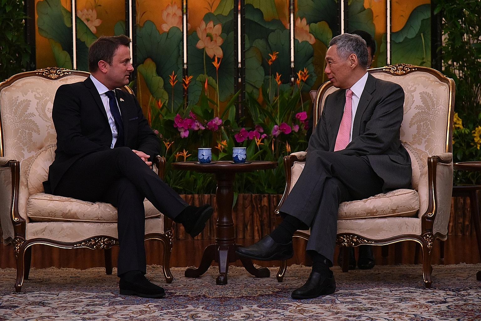 Luxembourg's Prime Minister Xavier Bettel (left) discussing regional and international developments with Prime Minister Lee Hsien Loong at the Istana yesterday. Mr Lee hosted Mr Bettel to dinner at the Istana last night and a tour of Gardens by the B