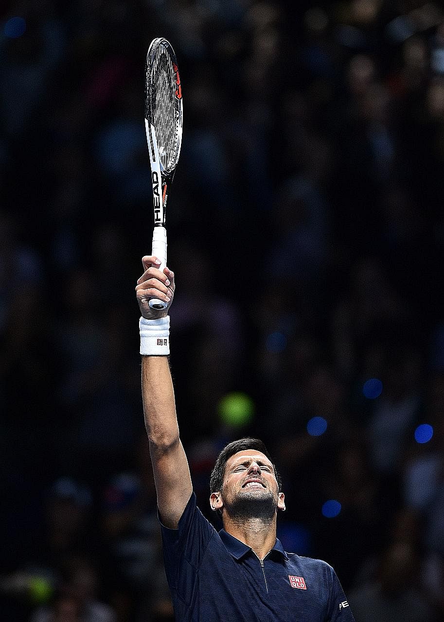 Novak Djokovic shows his relief after his 7-6 (8-6), 7-6 (7-5) win against Milos Raonic at the ATP World Tour Finals in London on Tuesday. The Serb dropped his serve twice in the second set but held on to win.