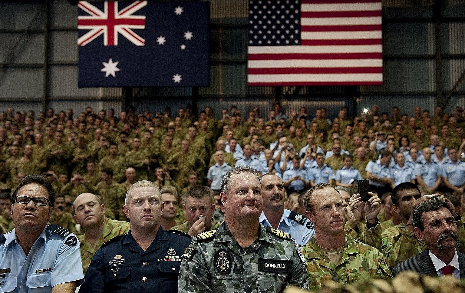 Australian troops and US Marines listening as Mr Obama gave a speech at the Royal Australian Air Force's Base Darwin in 2011. Australian troops have fought alongside the US' in each of its foreign wars.
