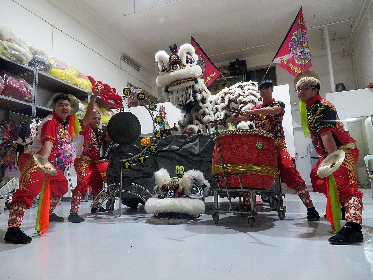 Some lion dance troupe members of the Singapore Teng Ghee Athletic Association. Training for such troupes now incorporates technology, and the groups market themselves through social media. They also help each other out with manpower.
