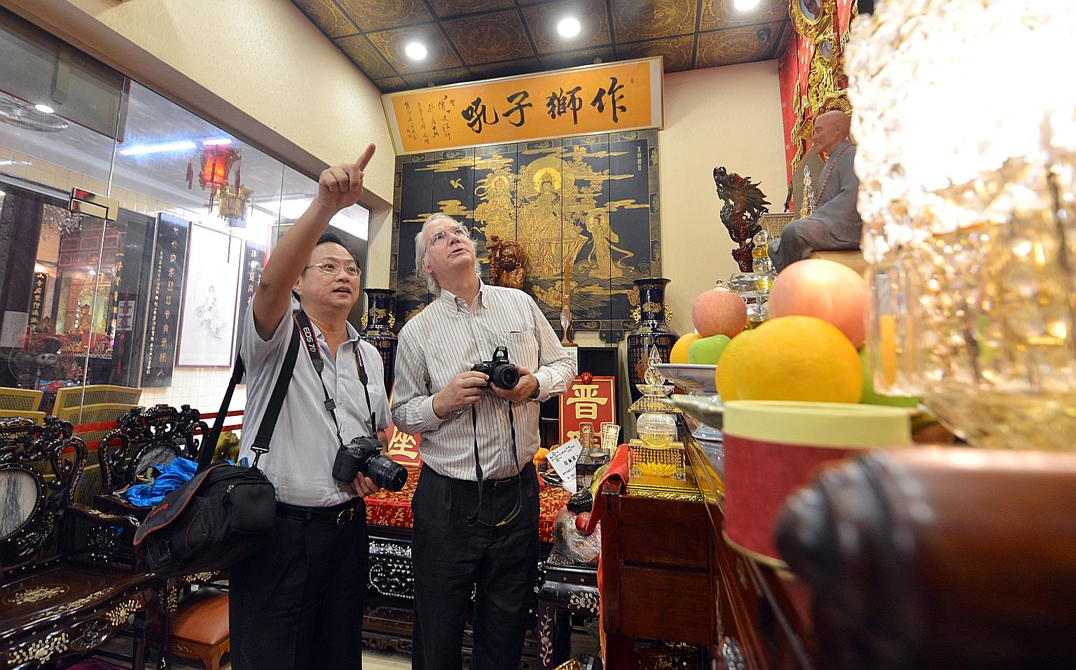 Professor Dean (left) and Dr Hue (far left), seen here at Leong San See Temple in Race Course Road, have been recording, photographing, analysing and translating Chinese inscriptions into English from 63 Buddhist and Taoist temples, clans and guild h