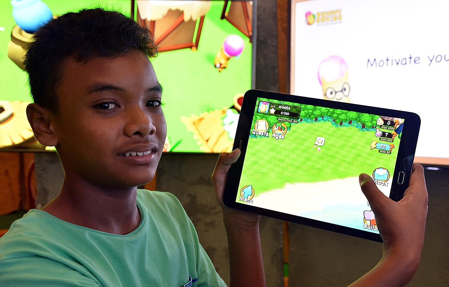 Irfan Shah, 12, playing with Brainy Arkies, a a new mobile learning app by Marshall Cavendish Education aimed at pupils from Primary 1 to 4, consisting of a series of maths quizzes combined with a gaming quest.