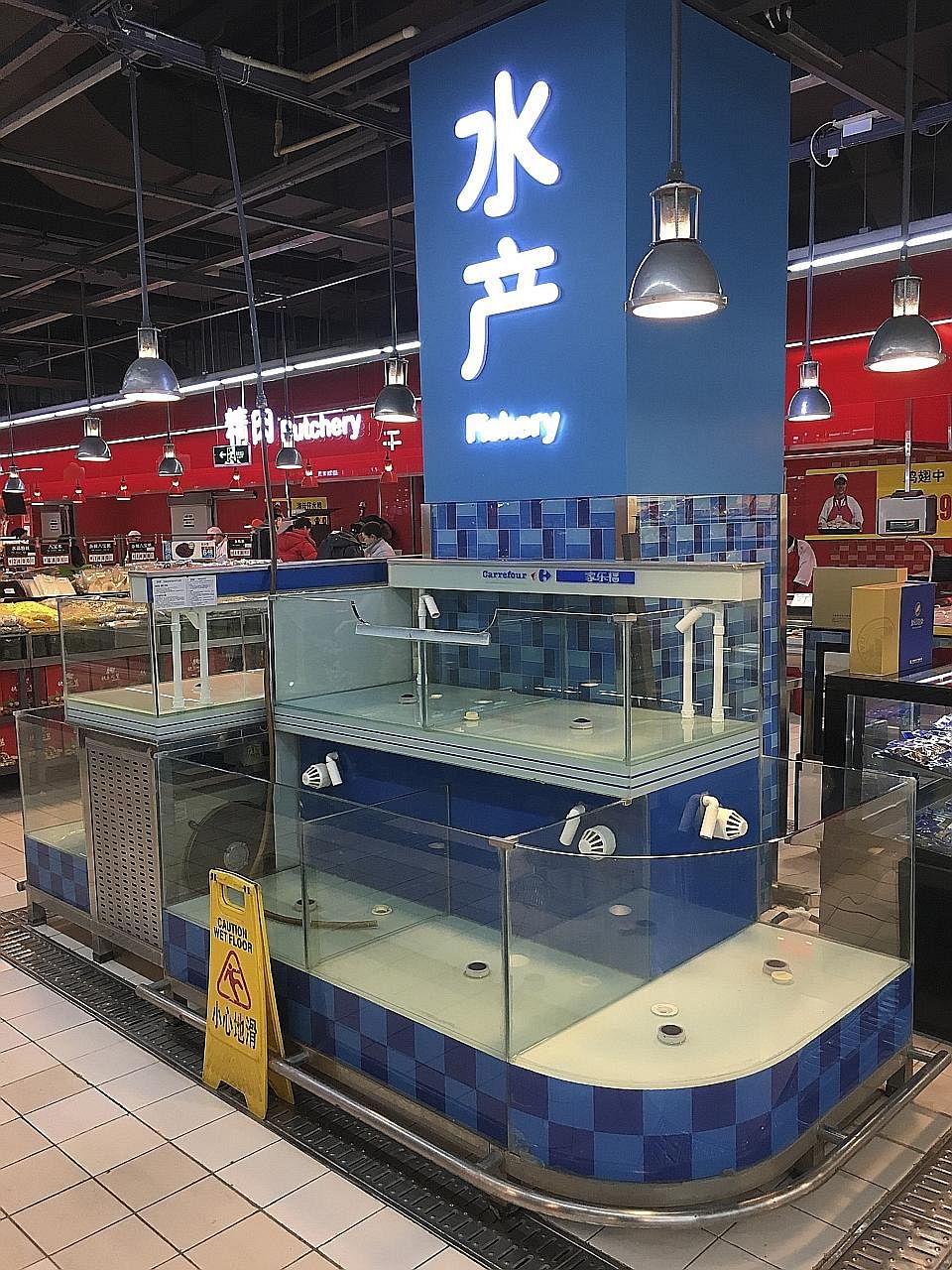 Tanks that normally hold freshwater fish left empty in a Carrefour supermarket in Beijing on Thursday. Not all supermarkets in the city have removed their live fish, but fish in many other stores are gone with no explanation.