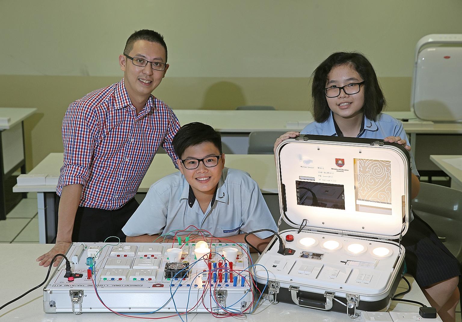 Chong Boon Secondary students Lim Yung Shan (centre) and Ea Xin Jie, both 14, will be taking the applied subject, smart electrical technology, next year. It will be taught by teacher Larry Lim, 38, who said: "Smart home systems are gaining popularity