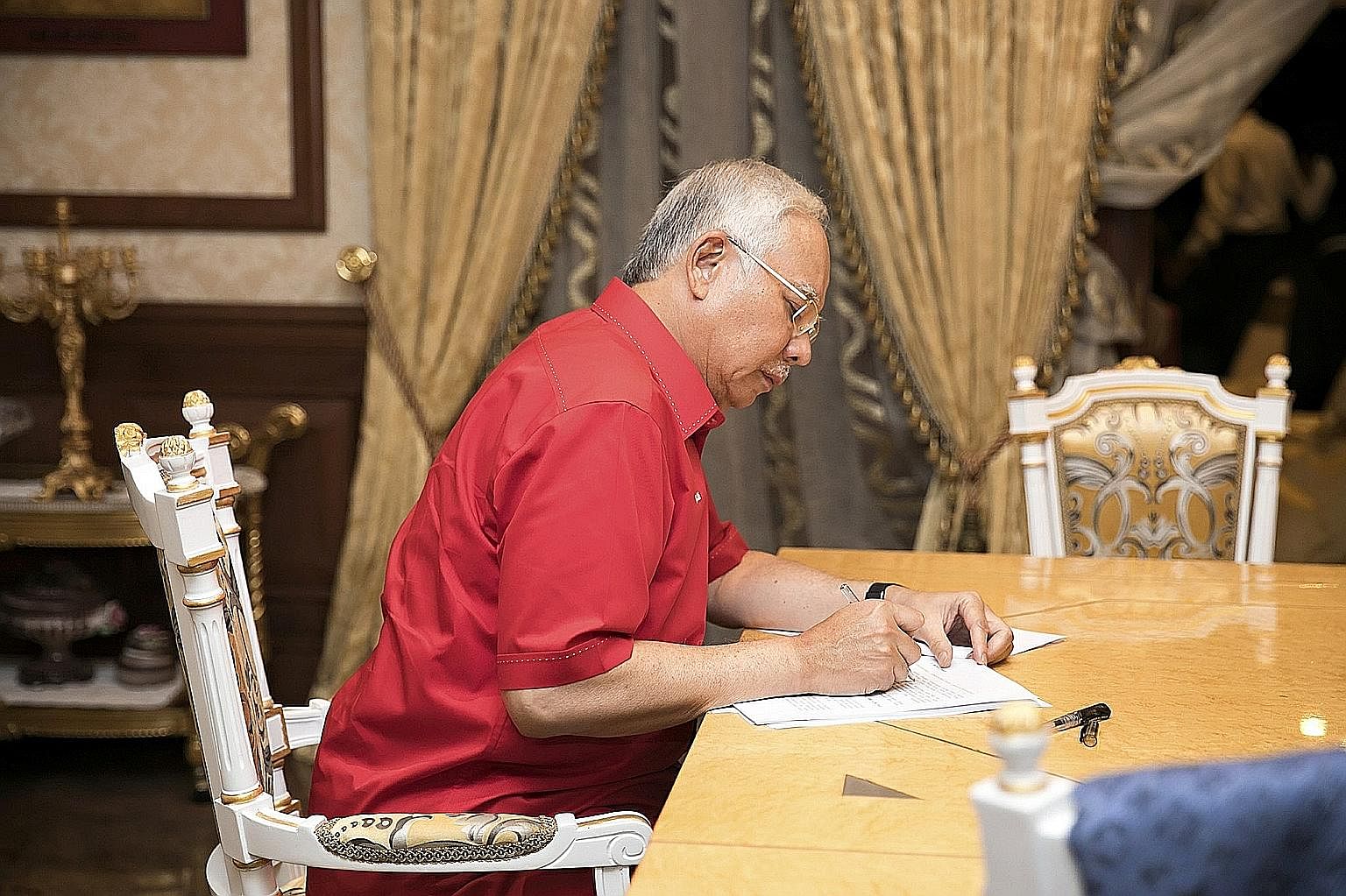 Mr Najib putting the final touches to his speech to the Umno general assembly yesterday.