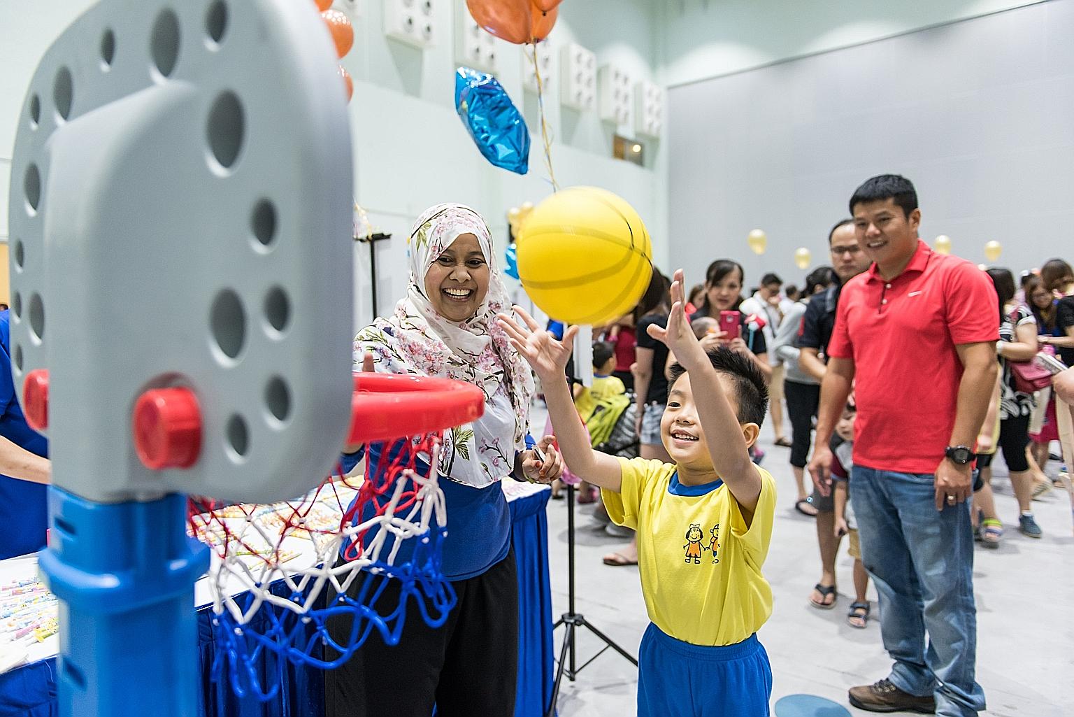 A Star Learners' childcare centre pupil playing at the centre's charity fun fair in July. The event raised $15,000 for The Straits Times School Pocket Money Fund.