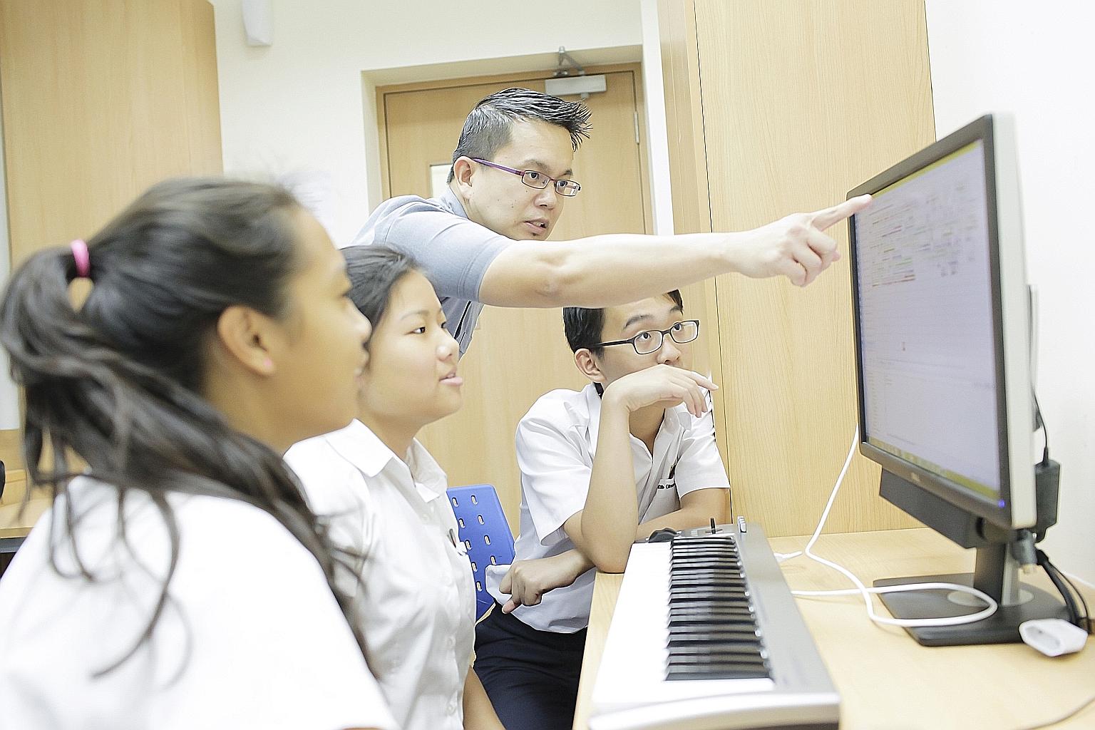 Mr Philip Tan teaching a class at ACS International. He uses visual methods to engage his students. When working with young students, for example, he teaches them how to arrange objects to put a musical passage together.
