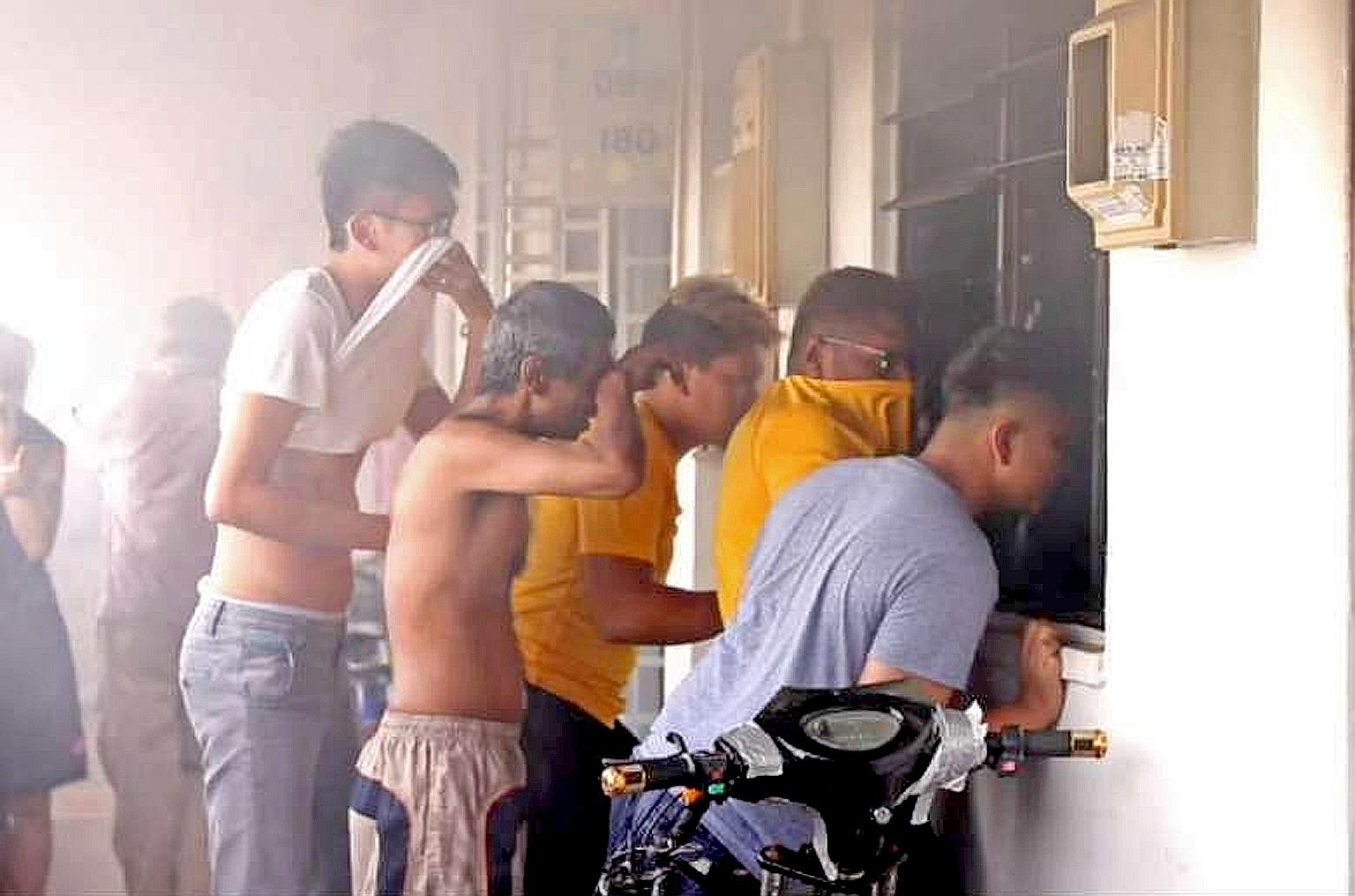 Residents trying to get the key to help free the trapped man. A video online also showed one throwing buckets of water into the unit.