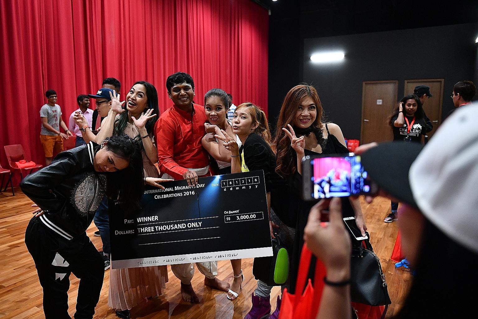 Mr Velucharmy Muniapparaj (centre), 30, an operations executive who was the winner at the finals of the Our Migrant Workers Got Talent 2! competition yesterday, posing for photos with fellow participants.