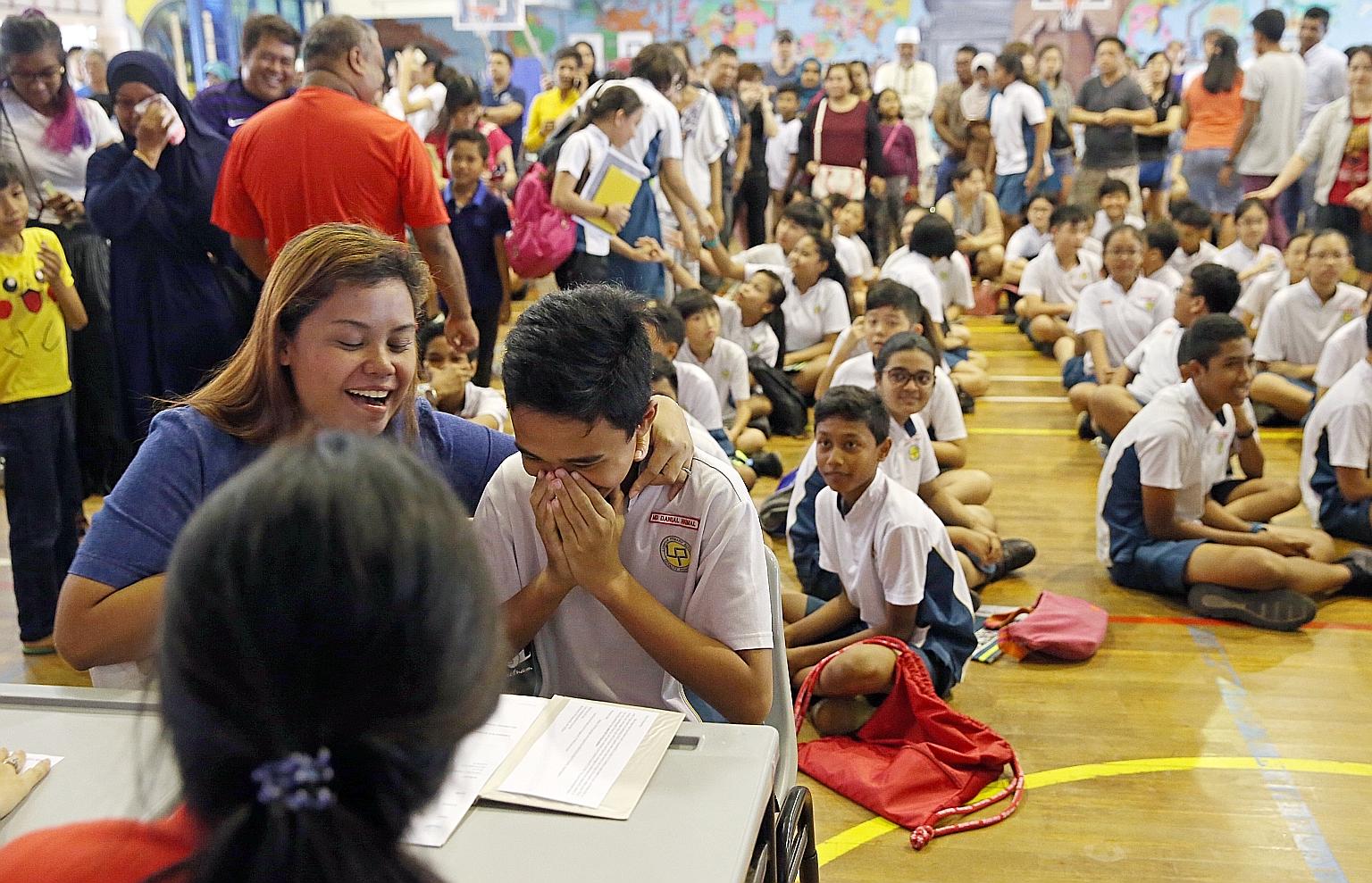 A Lianhua Primary pupil getting his PSLE results last month. Students were told yesterday of their secondary school postings.