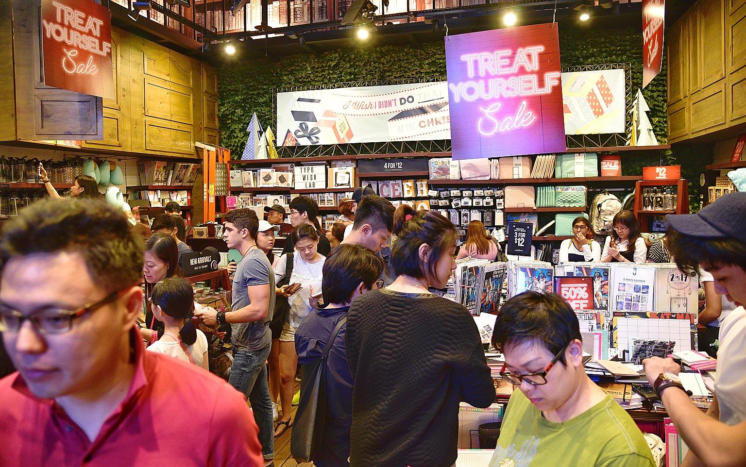 Shops in Orchard Road were packed yesterday when The Straits Times visited in the evening as masses of shoppers jostled with tourists and sightseers photographing the Christmas decorations and street performers.