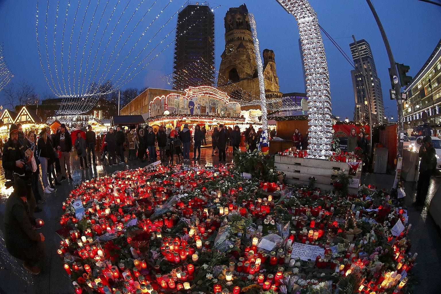 Flowers and candles near the Christmas market at Breitscheid square in Berlin following the Dec 19 truck attack. Anis Amri, who had driven a stolen truck through the crowd, was shot dead by police in Milan on Dec 23.